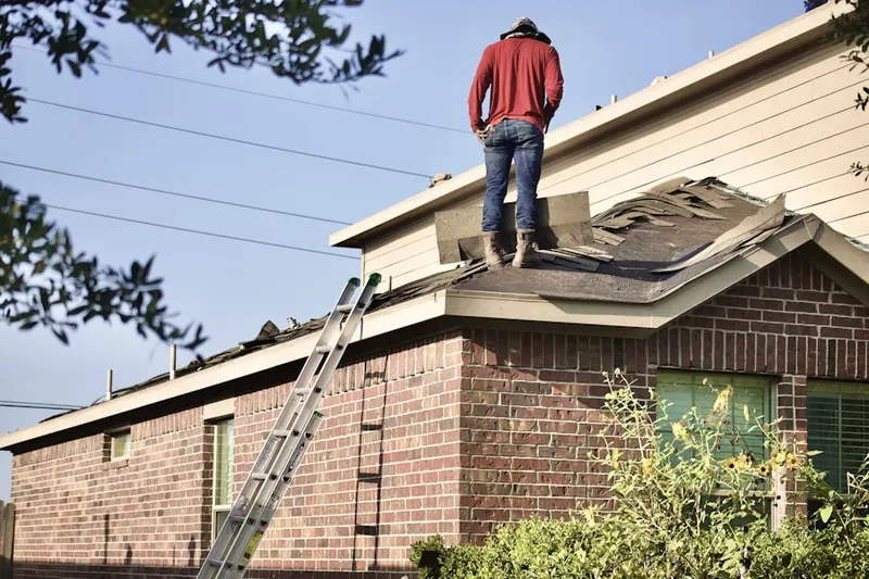 Professional roofer working on a residential roof in Collinsville